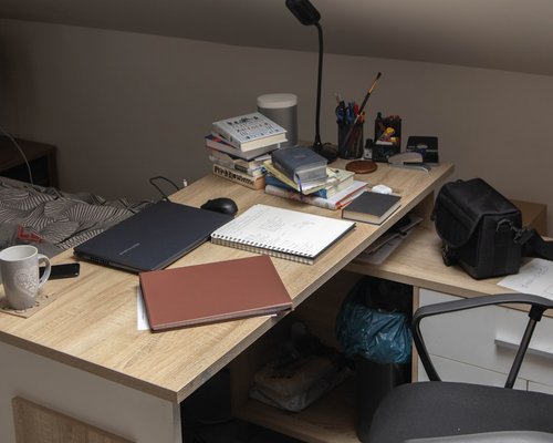 Person organizing a minimalist and aesthetic desk setup